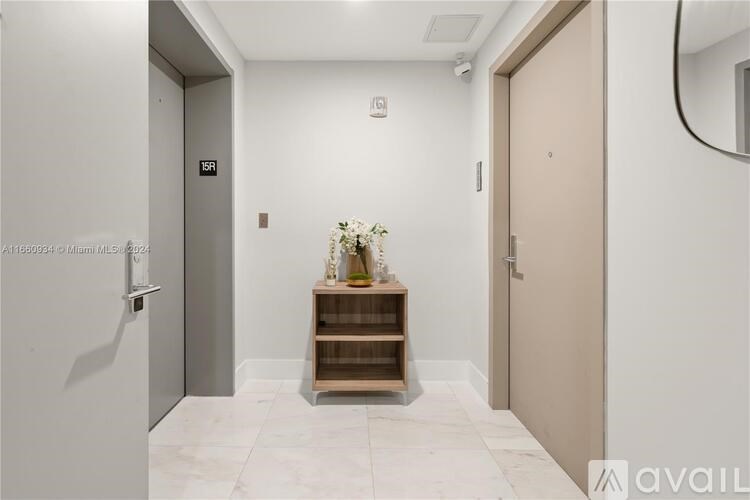A hallway with a bench and a mirror on the wall.