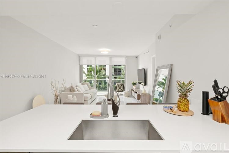 A modern kitchen with a large island and a sink.
