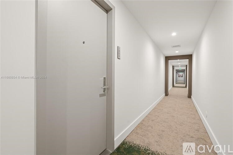 A long hallway with a door on the left and a door on the right.