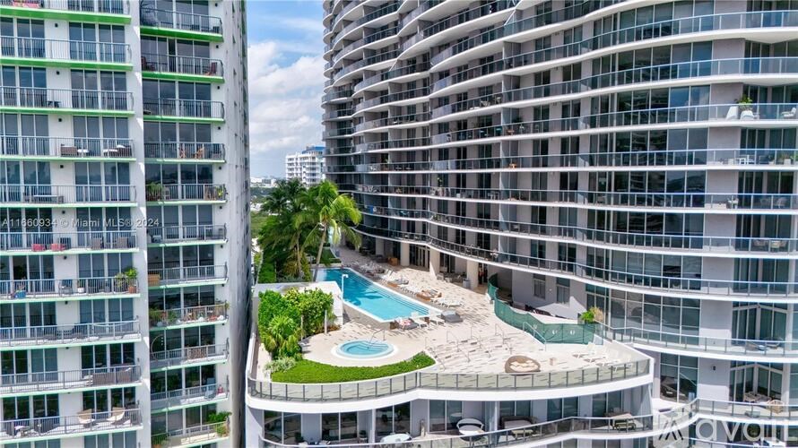 A modern building with a pool in the courtyard.