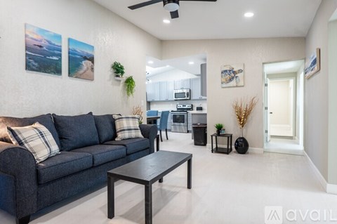 A living room with a grey couch and a coffee table.