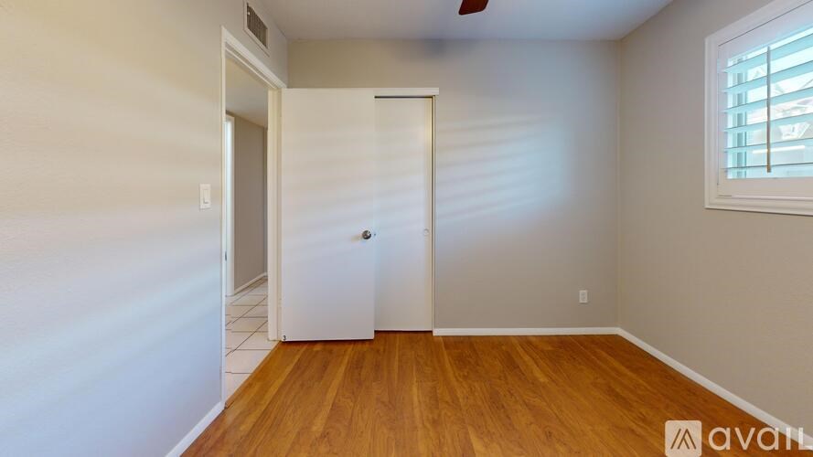 A room with wooden flooring and a white door.