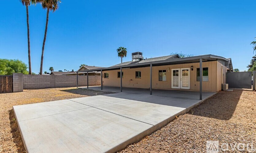 A house with a concrete driveway in front of it.