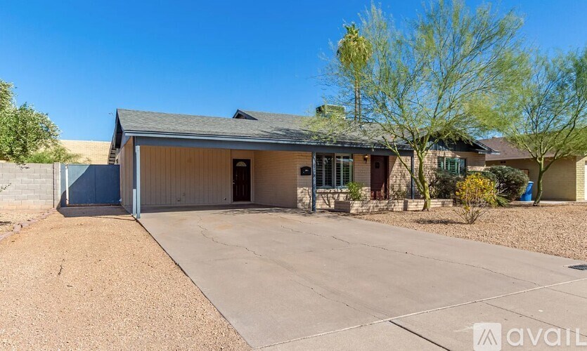 A house with a garage and a driveway in front of it.