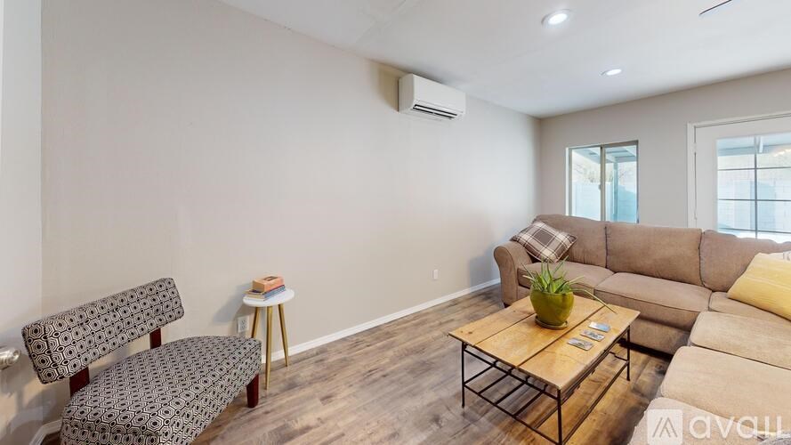 A living room with a couch, chair, and coffee table.