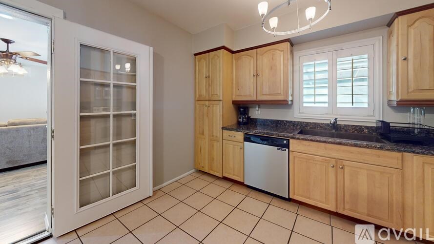 A kitchen with wooden cabinets and a black countertop.