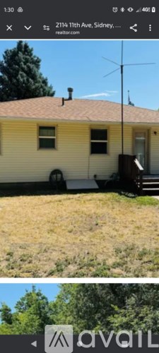 A yellow house with a white door and a brown roof.
