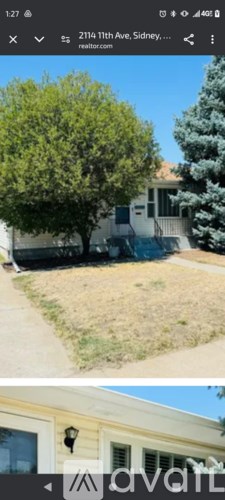 A house with a tree in front of it.