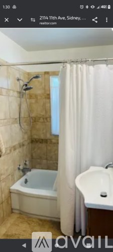 A bathroom with a shower, bathtub, and sink.