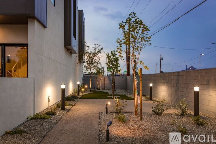 A modern house with a pathway leading to the front door.