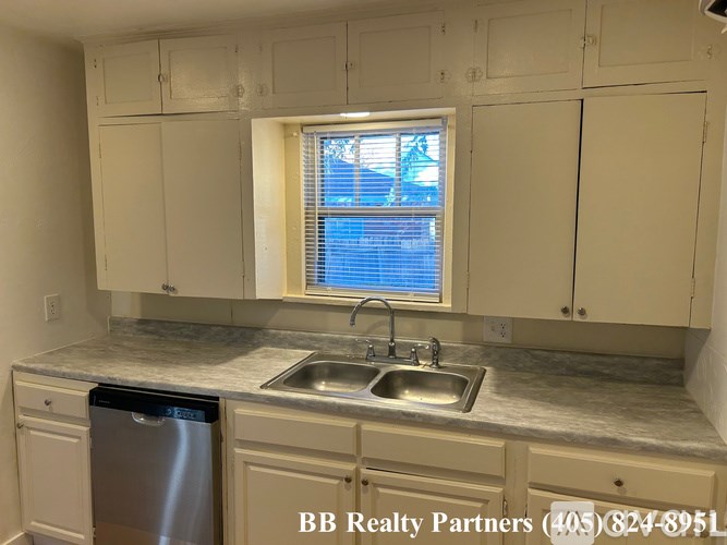 A kitchen with a sink and a window.