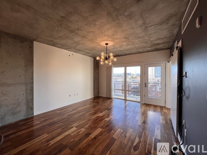 A room with wooden floors and a chandelier.