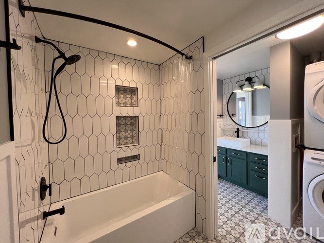 A bathroom with a white tiled shower and a white bathtub.