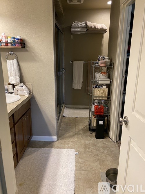 A bathroom with a white towel hanging on a towel rack.