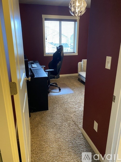 A room with a desk and a chair.