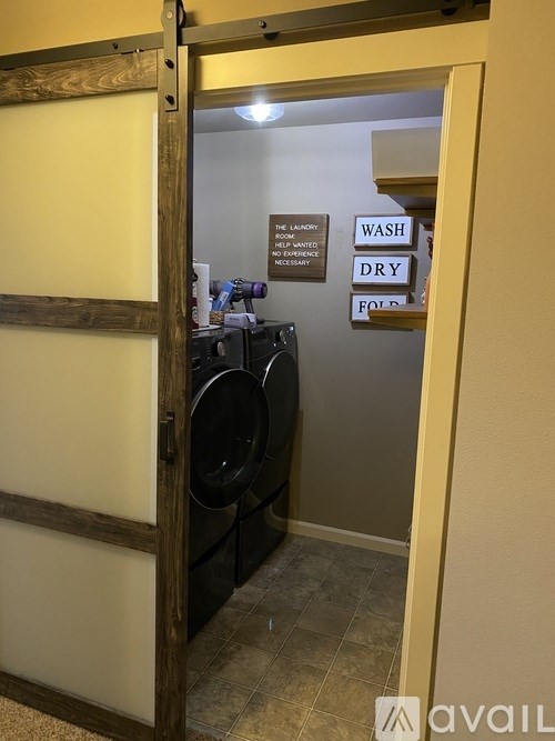 A laundry room with a sign that says "Wash Dry Fold".