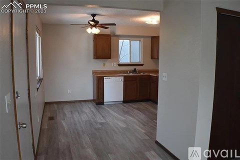 A kitchen area with a dishwasher and a ceiling fan.