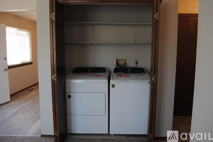A small laundry room with a washer and dryer.