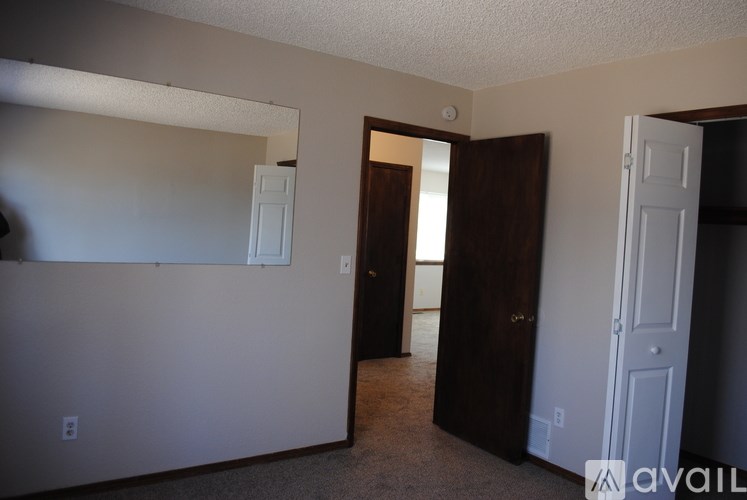 A room with a white door and a brown door.