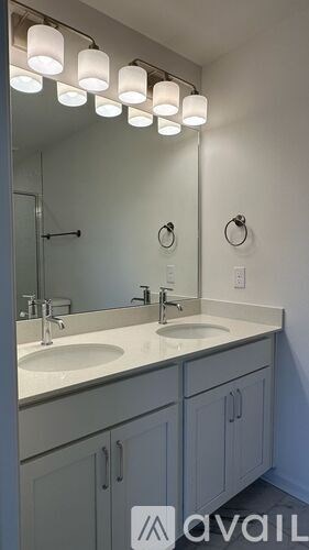 A bathroom with two sinks and a mirror.