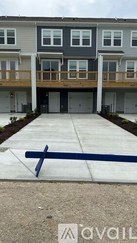 Apartment complex with a blue cross painted on the ground in front.