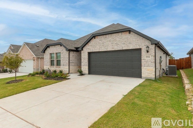A house with a garage and a driveway in front.