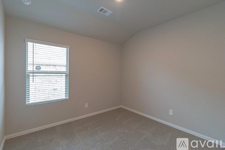 A room with a window and carpeted floor.