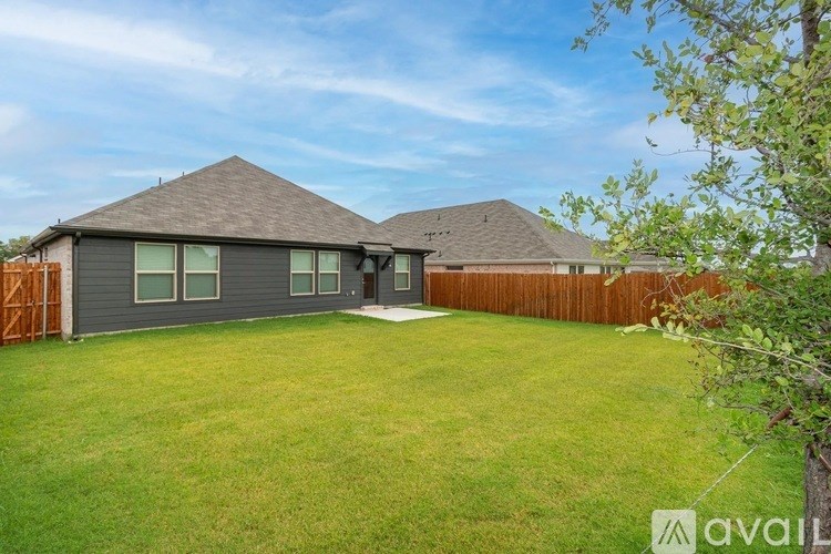 A house with a grey roof and a brown fence.