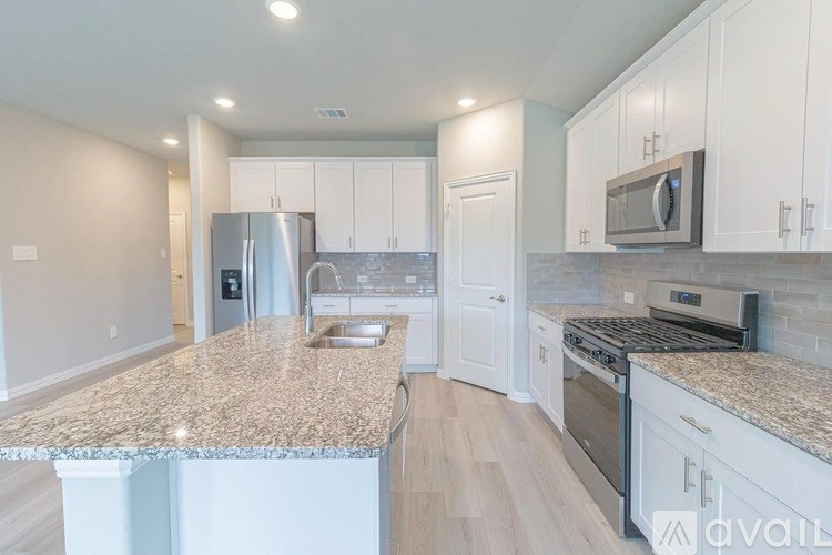A kitchen with granite countertops and stainless steel appliances.