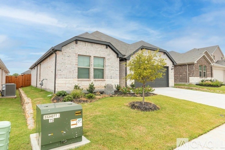 A house with a green utility box in front of it.