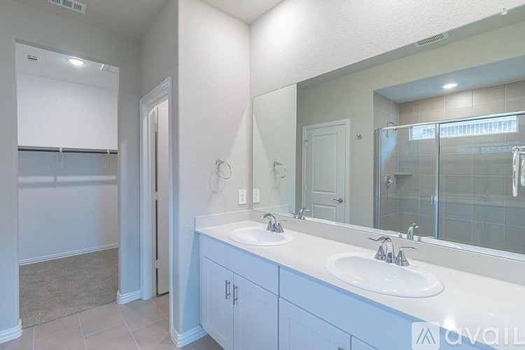 A bathroom with two sinks and a large mirror.