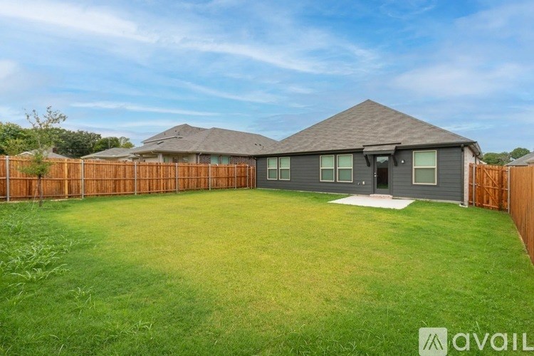 A house with a grey roof and a brown fence.