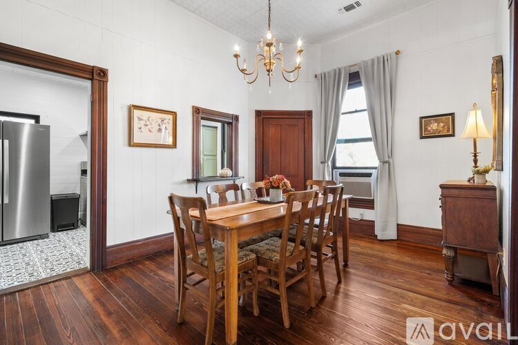 A dining room with a wooden table and chairs.
