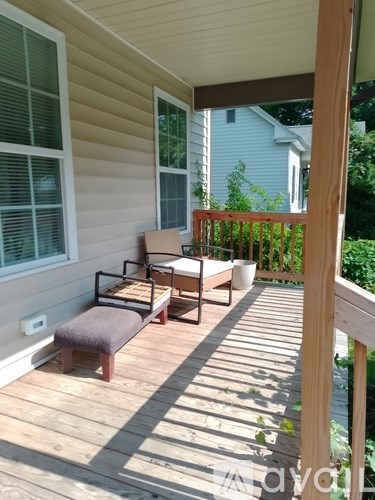 A wooden deck with a bench and a table.