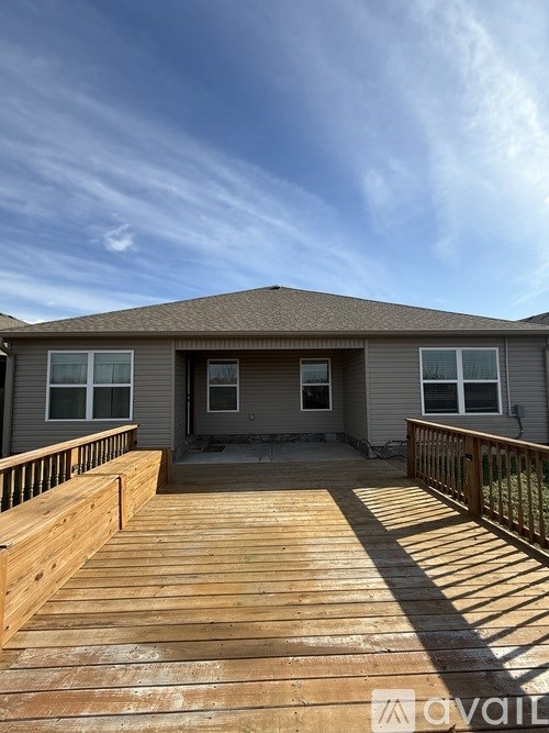 A house with a deck in front of it.