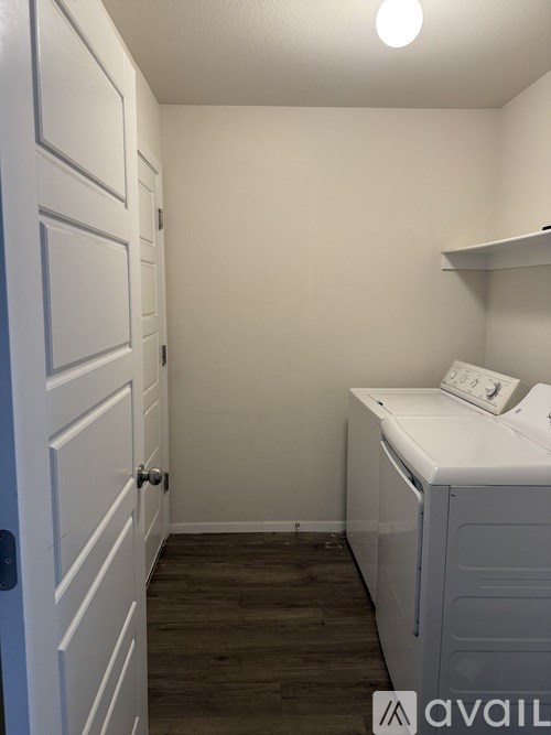 A small laundry room with a washer and dryer.