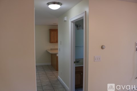 A kitchen area with a sink and a refrigerator.