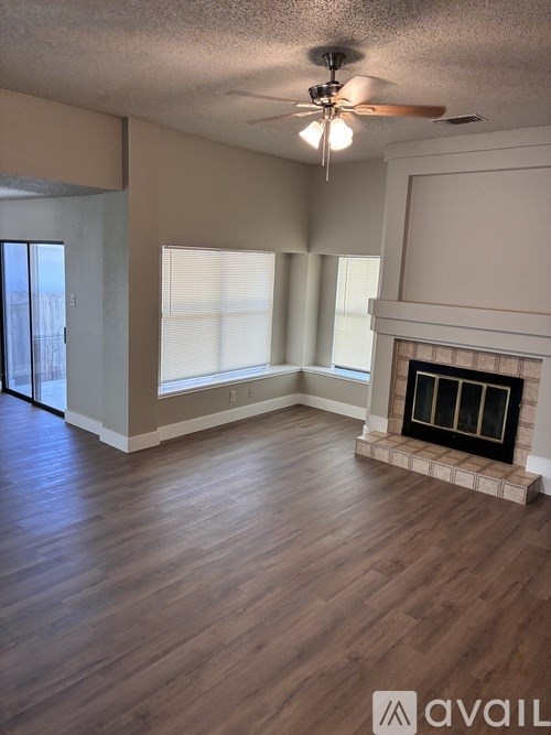 A room with a ceiling fan and a window.