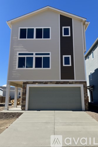 A two-story house with a garage is available for sale.