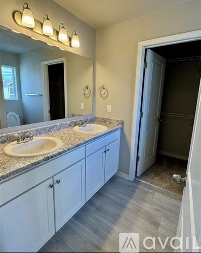 A bathroom with a vanity and a mirror.