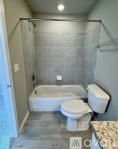 A white toilet and sink in a bathroom.