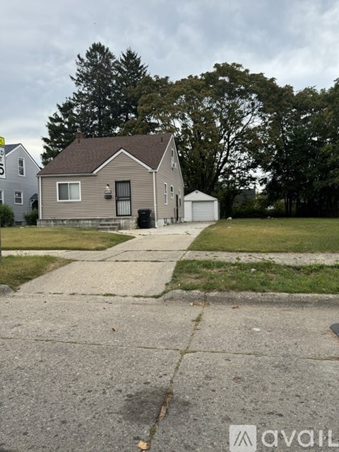 A house with a garage is situated in a residential area.