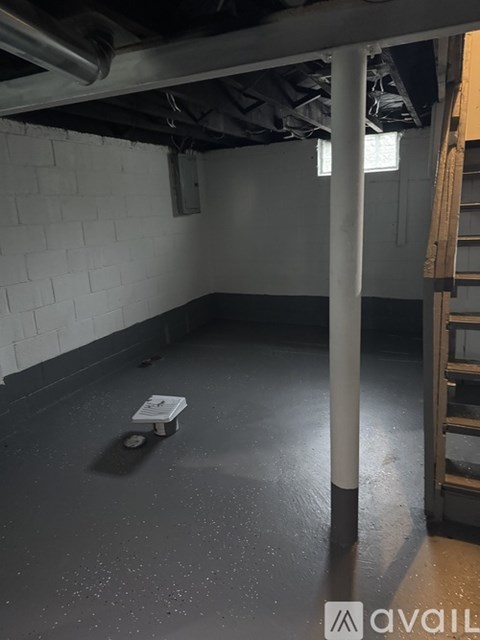 A room with a white brick wall and a concrete floor.