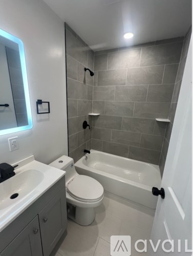 A bathroom with a toilet, sink, and bathtub.