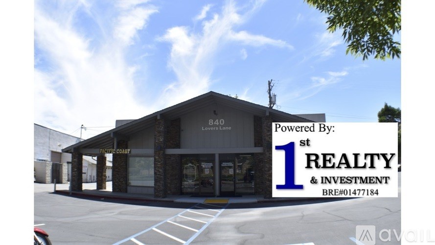 A building with the sign "1st REALTY & INVESTMENT" on the front.