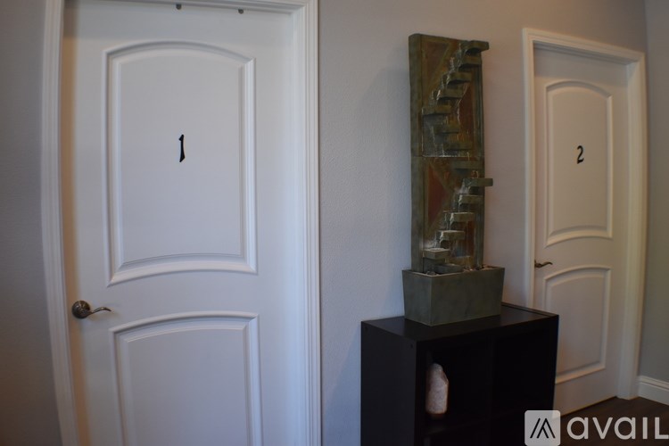 A white door with a black frame is labeled with the number 1.