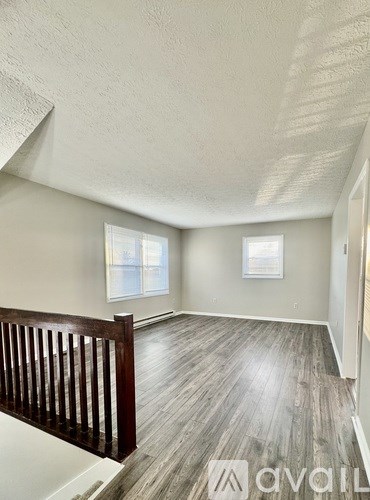 A room with wooden floors and a window.