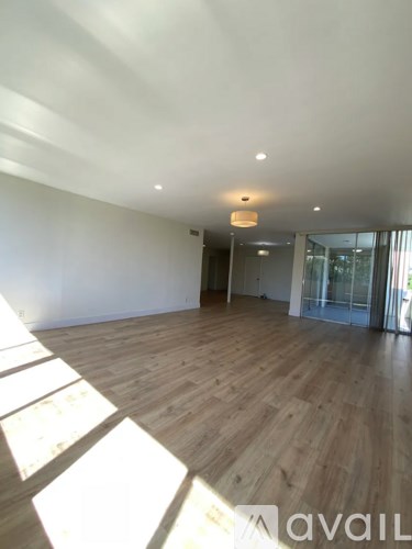 A room with wooden floors and white walls.