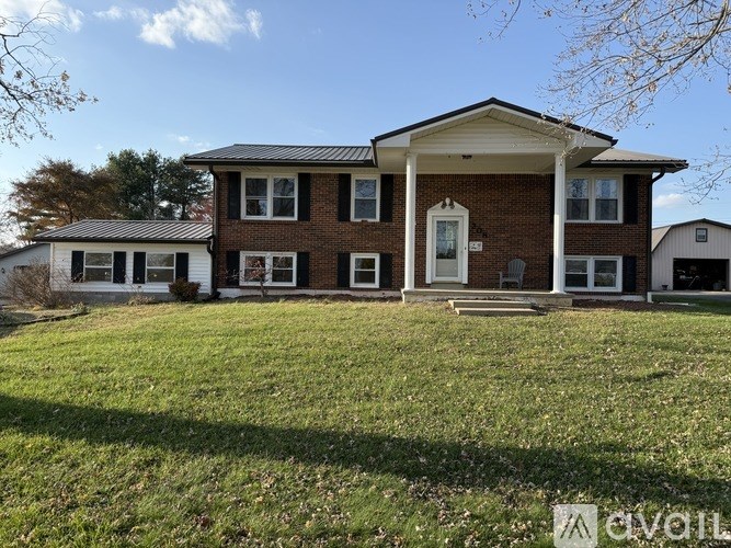 A house with a red brick exterior and a white roof.
