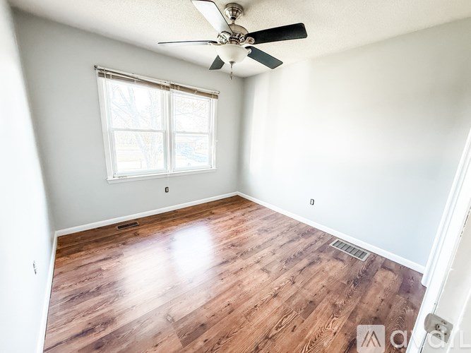 A room with a tiled floor and sliding glass doors.